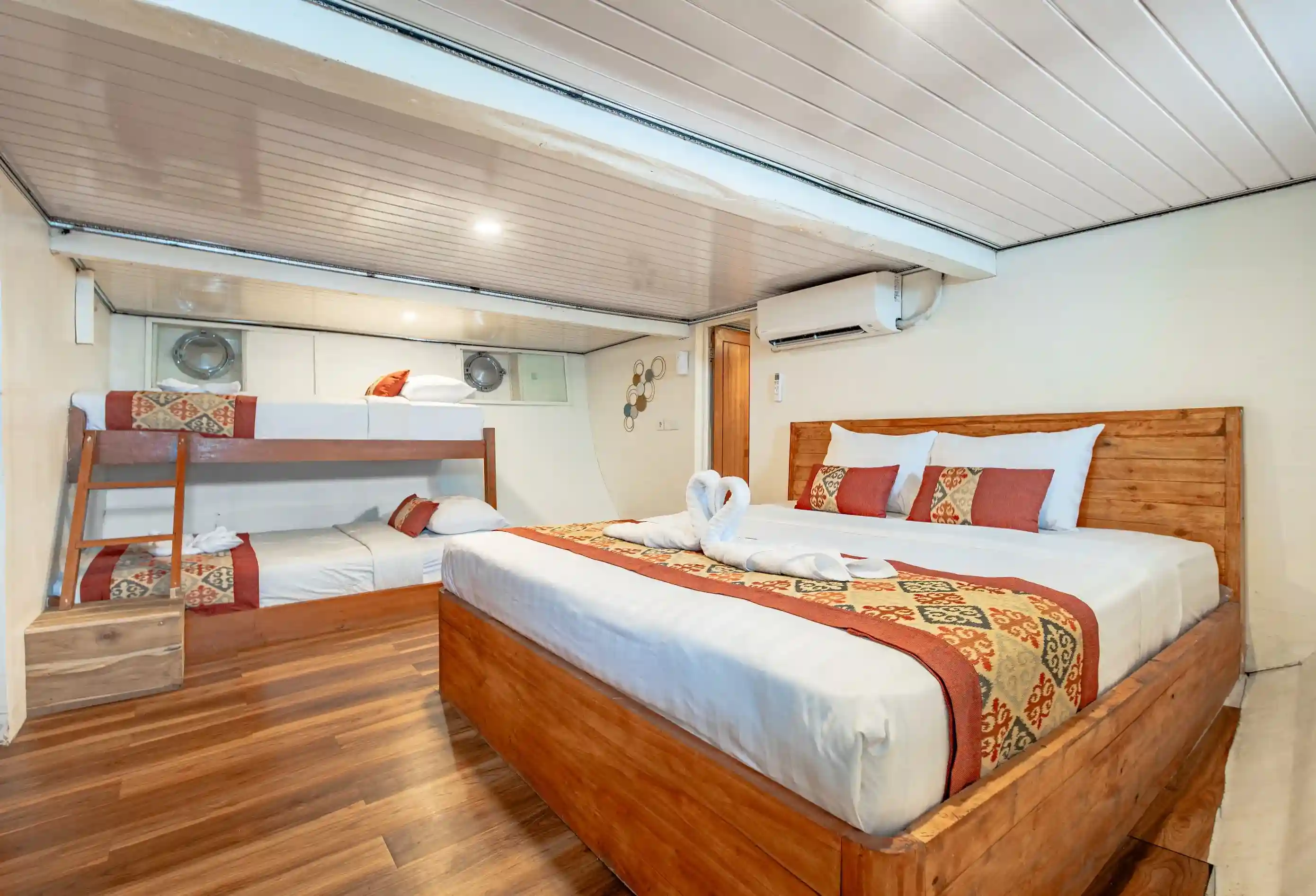 Family cabin on Magika Liveaboard with king bed and two single bunks