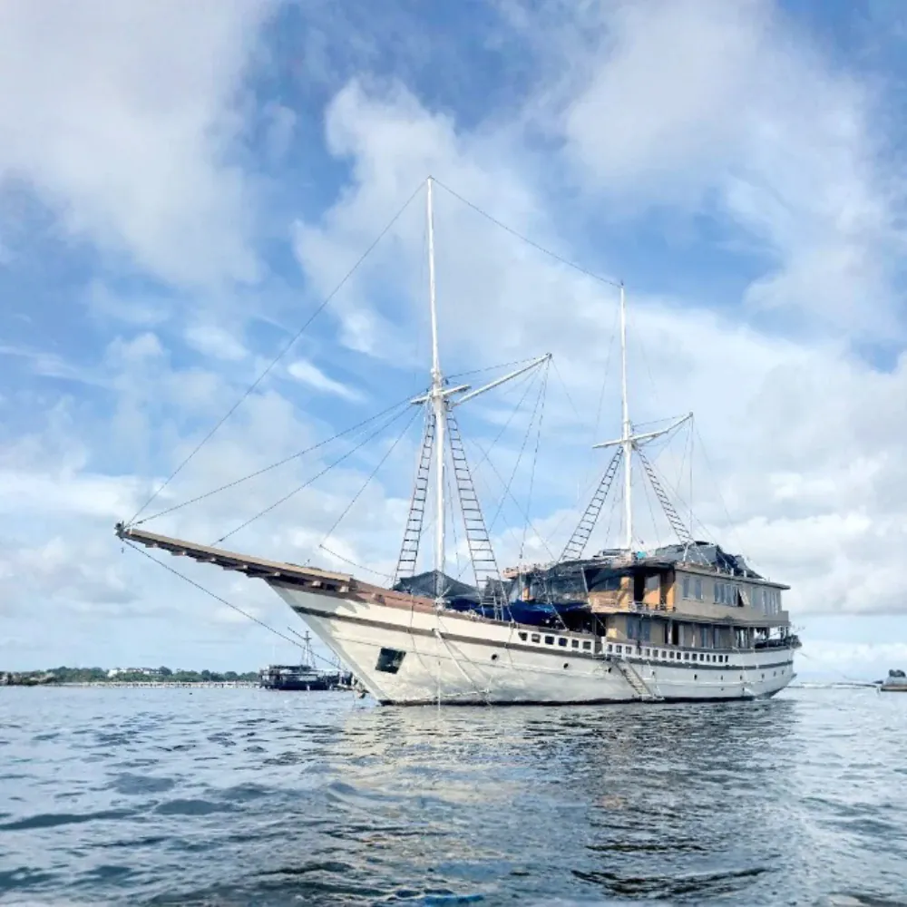 Magika phinisi at anchor in a sheltered Komodo bay