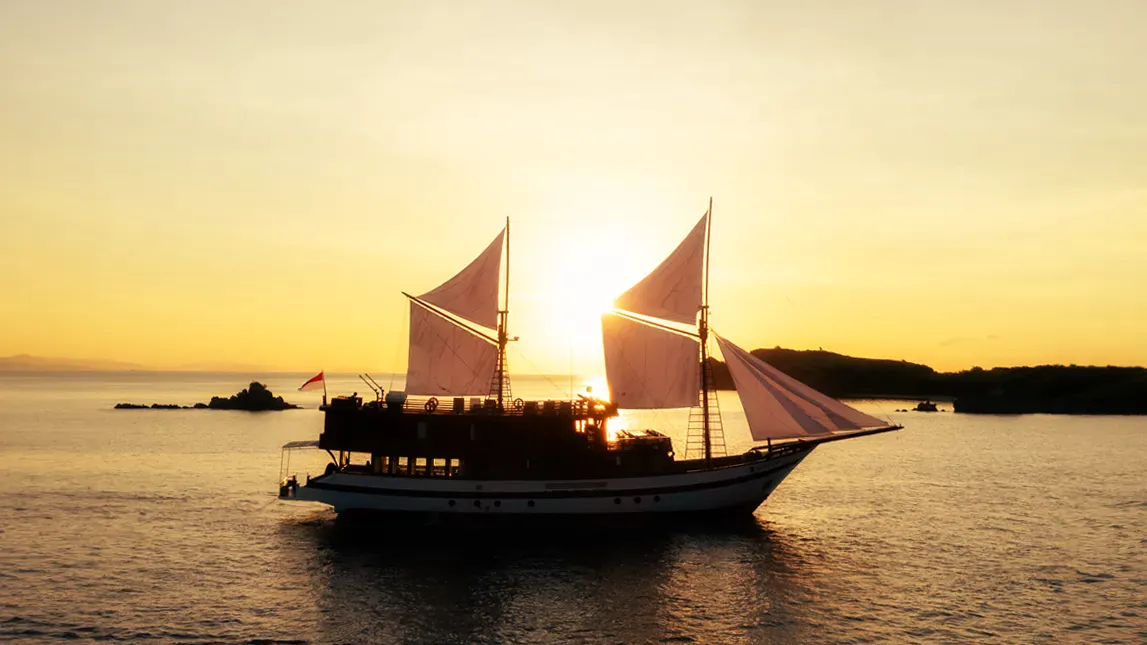 Magika phinisi at anchor at sunset in Komodo National Park